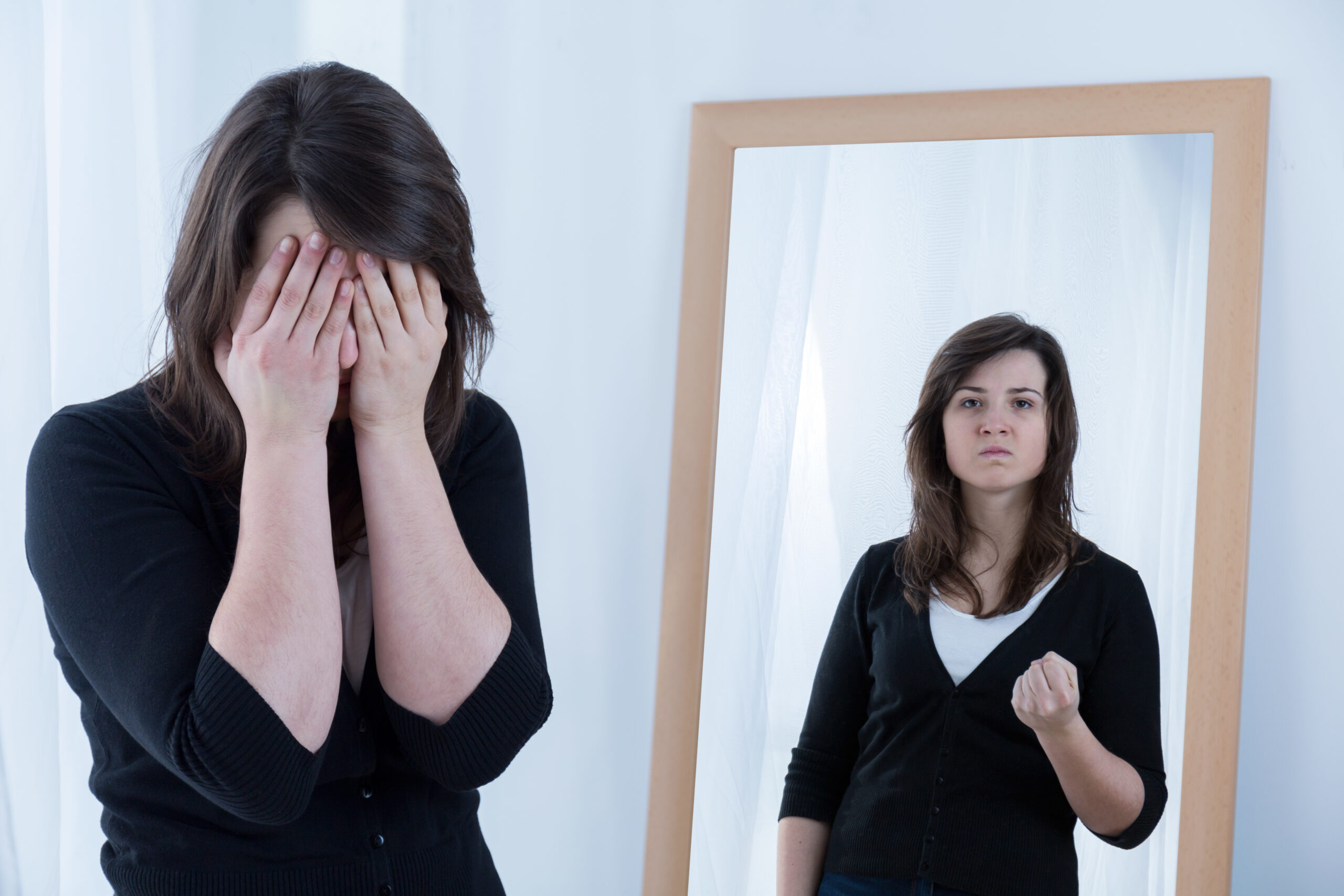 Woman and her true angry reflection in the mirror