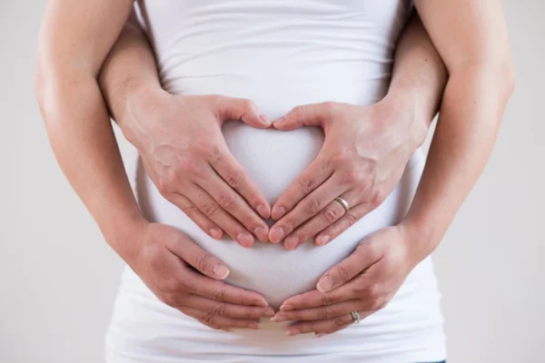fertility support guide with hands on belly